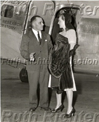 Paul Richter and Bette Davis standing next to NC18137