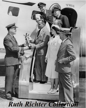 Paul E. Richter Jr., Executive Vice President of T.W.A., presents Tommy Tomlinson with a trophy